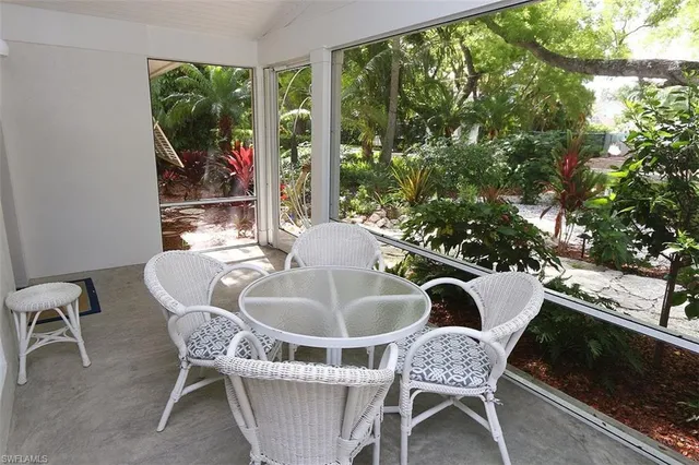 a dining room with furniture and a potted plant