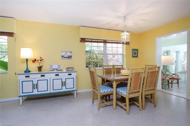 a view of a dining room with furniture and chandelier