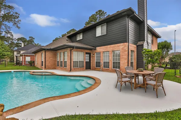 a view of a house with swimming pool and sitting area