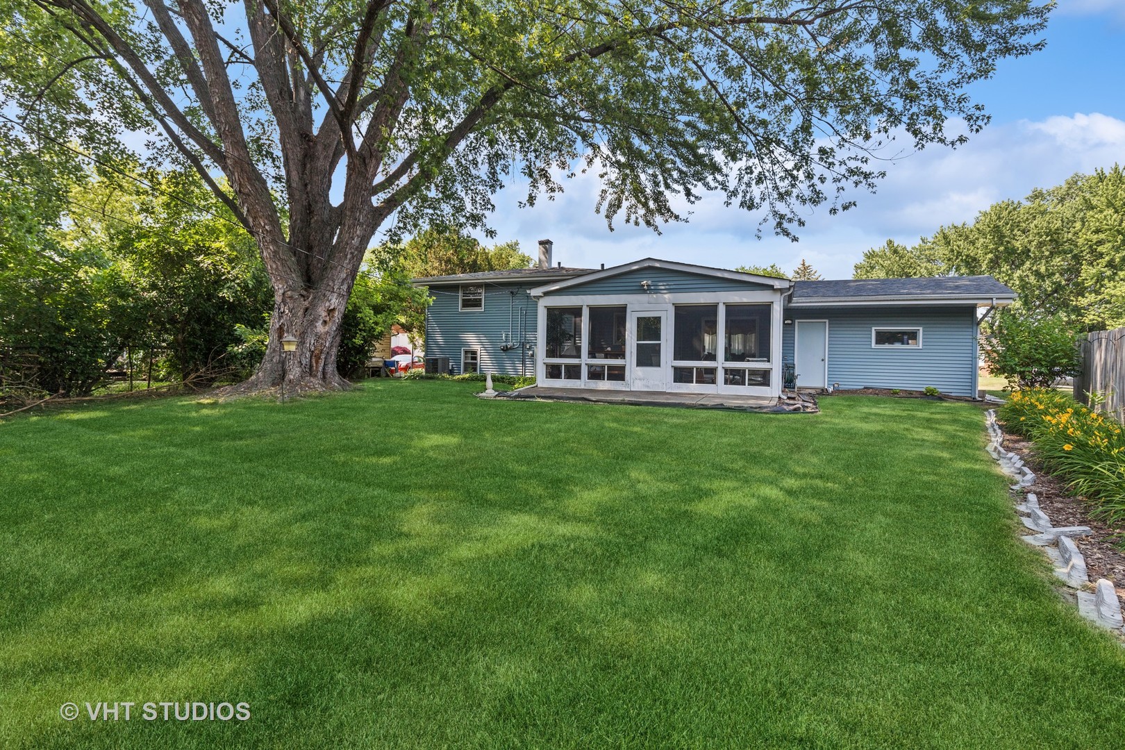 2107 Meadow Drive Lindenhurst, IL 60046 - Photo 13 of 18 a front view of a house with a garden