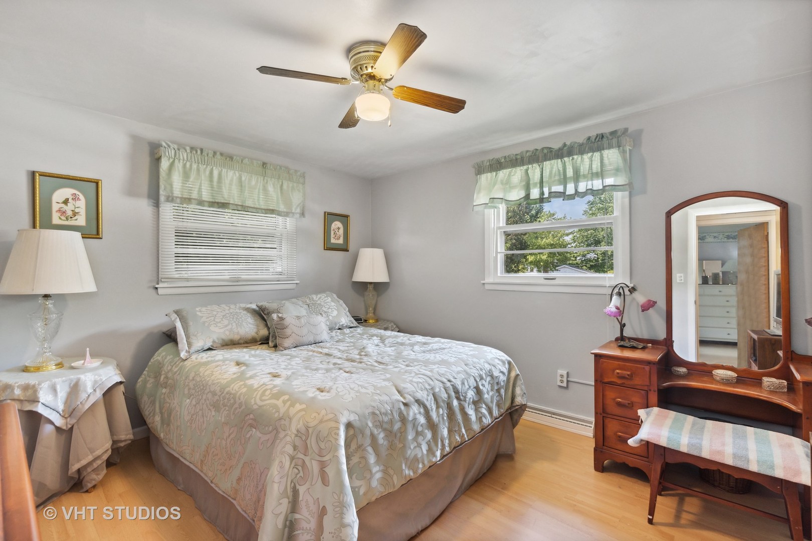 2107 Meadow Drive Lindenhurst, IL 60046 - Photo 9 of 18 a bedroom with a bed a mirror and a large window