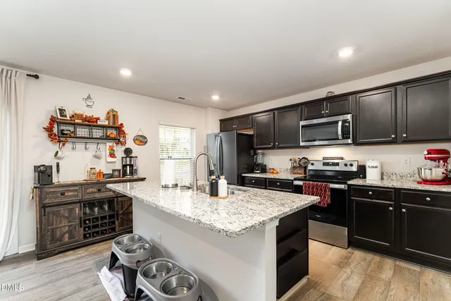 a kitchen with granite countertop a stove sink and cabinets