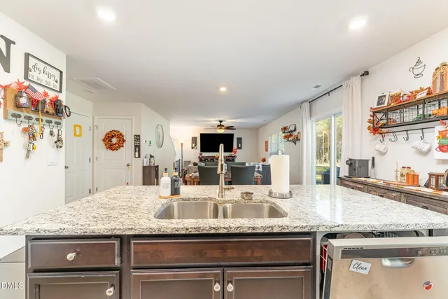a kitchen with granite countertop kitchen island stainless steel appliances and sink