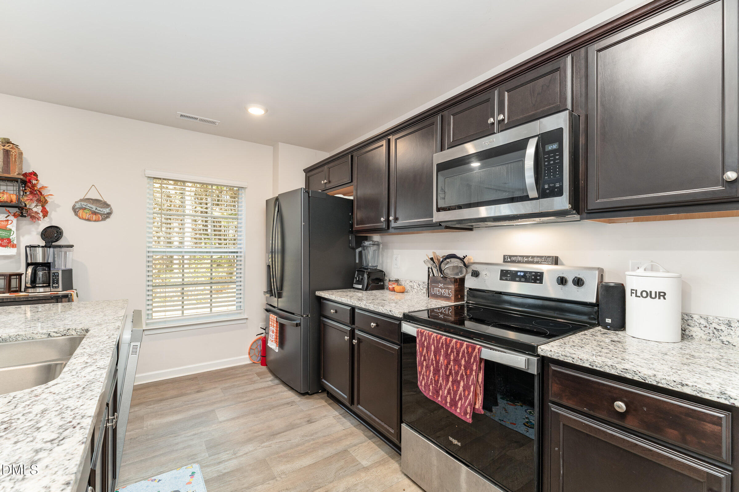 5496 Carolines Way Wilson, NC 27893 - Photo 19 of 71 a kitchen with stainless steel appliances granite countertop a stove a sink and a microwave