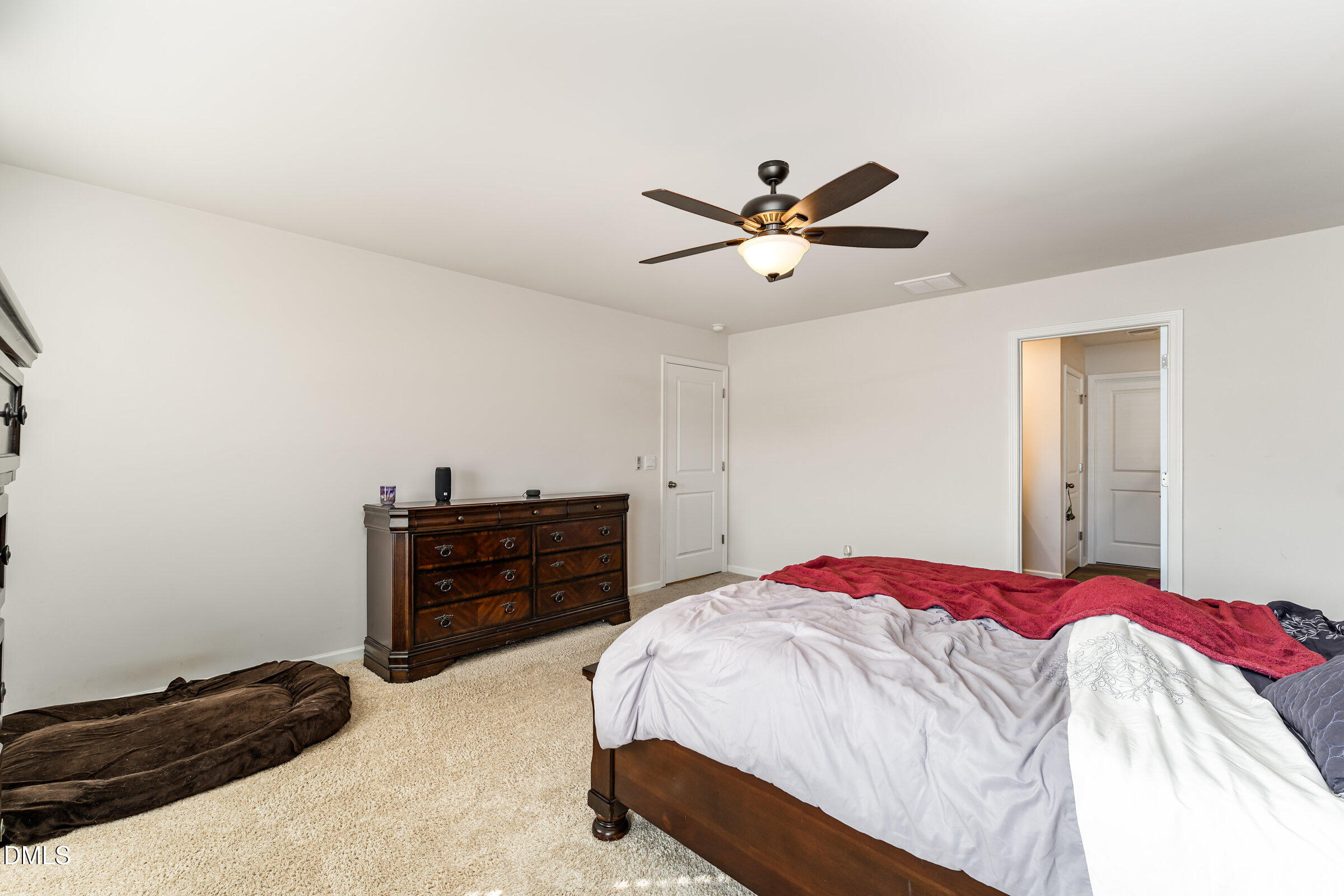 5496 Carolines Way Wilson, NC 27893 - Photo 32 of 71 a bedroom with a bed and a chandelier