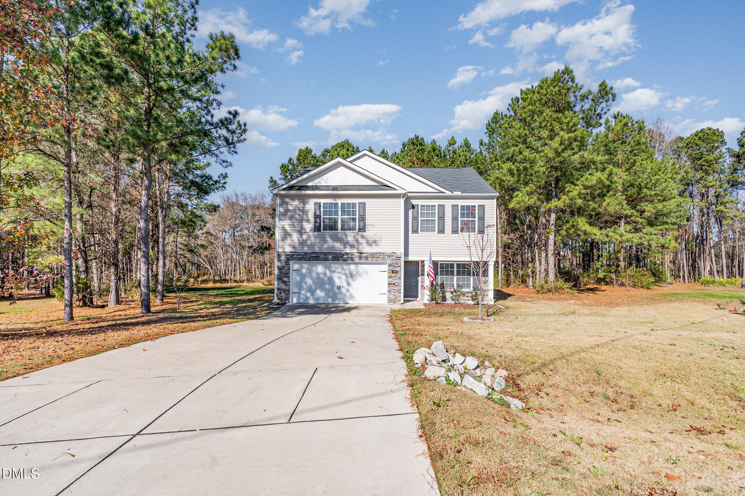 5496 Carolines Way Wilson, NC 27893 - Photo 47 of 71 a front view of a house with a garden