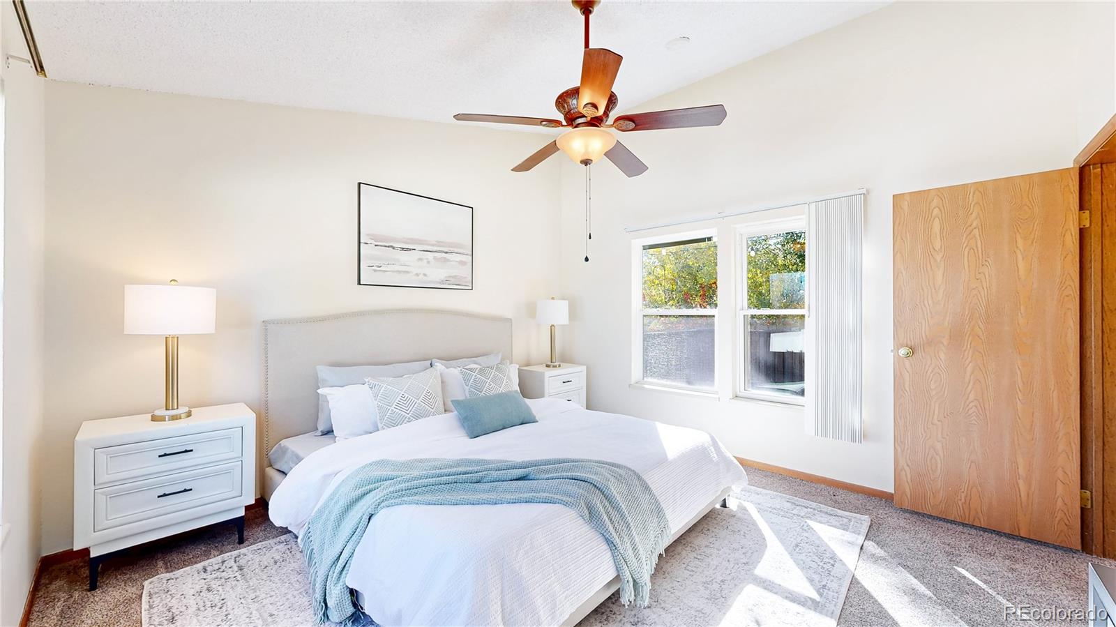 214 Poppy Street Golden, CO 80401 - Photo 11 of 31 a bedroom with a bed and a chandelier