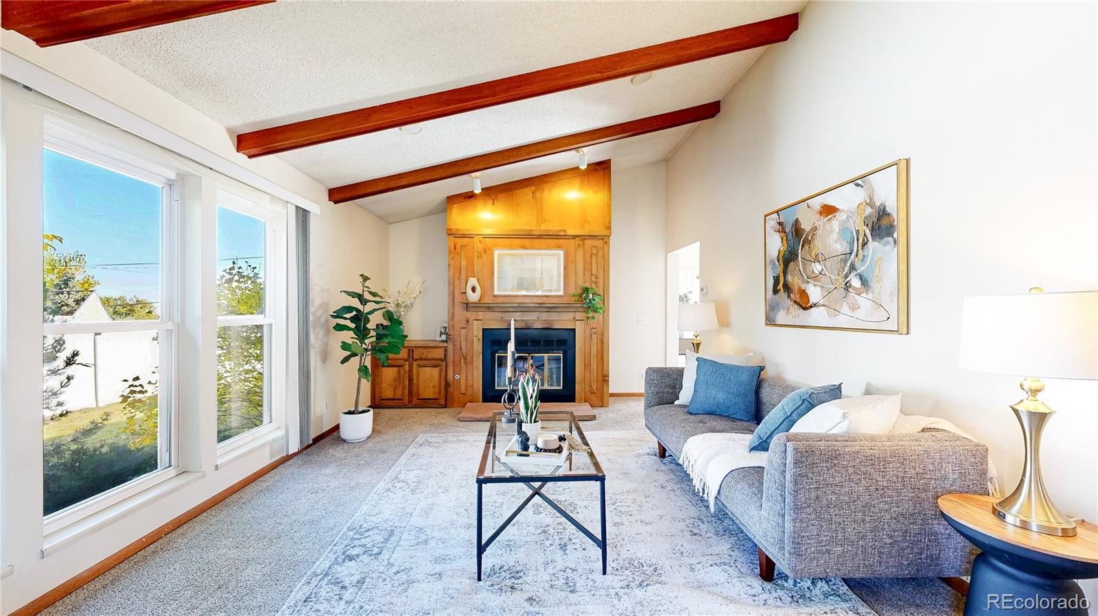 214 Poppy Street Golden, CO 80401 - Photo 2 of 31 a living room with furniture a fireplace and a large window
