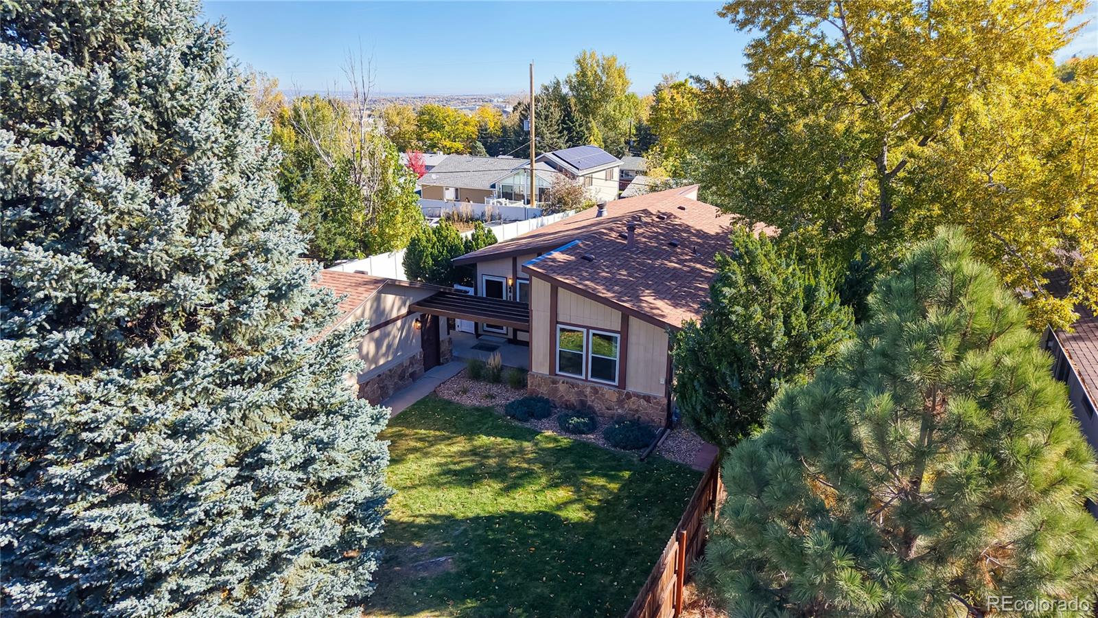 214 Poppy Street Golden, CO 80401 - Photo 23 of 31 a view of a house with a small yard and a large tree