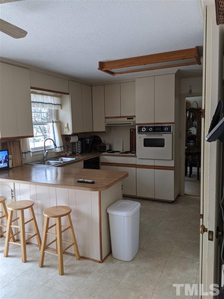 8804 Oneal Road Raleigh, NC 27613 - Photo 2 of 11 a kitchen with a white cabinets and white appliances