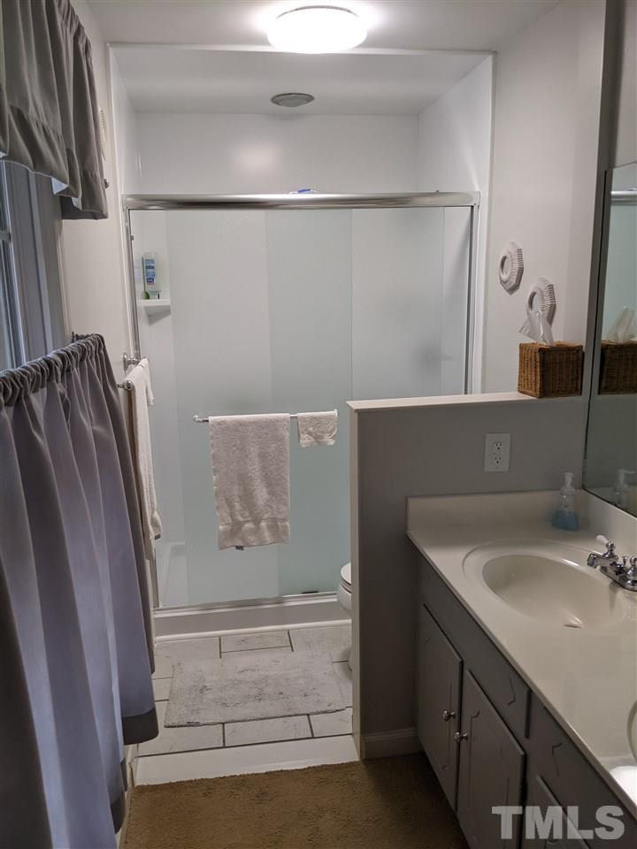 8804 Oneal Road Raleigh, NC 27613 - Photo 4 of 11 a bathroom with a sink and mirror
