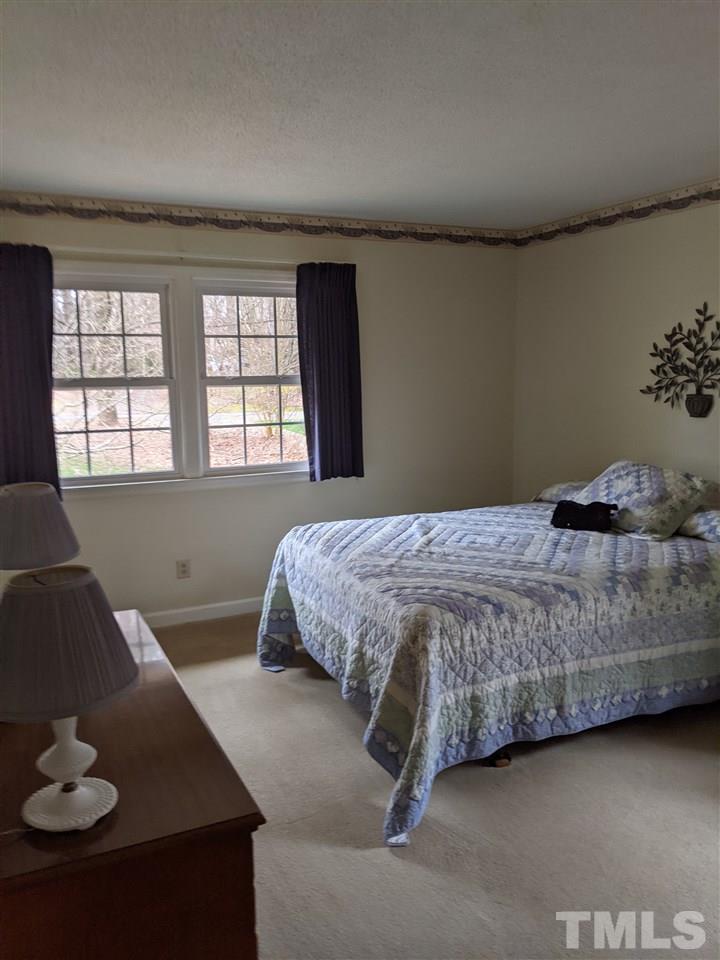 8804 Oneal Road Raleigh, NC 27613 - Photo 6 of 11 a bedroom with a bed and a couch