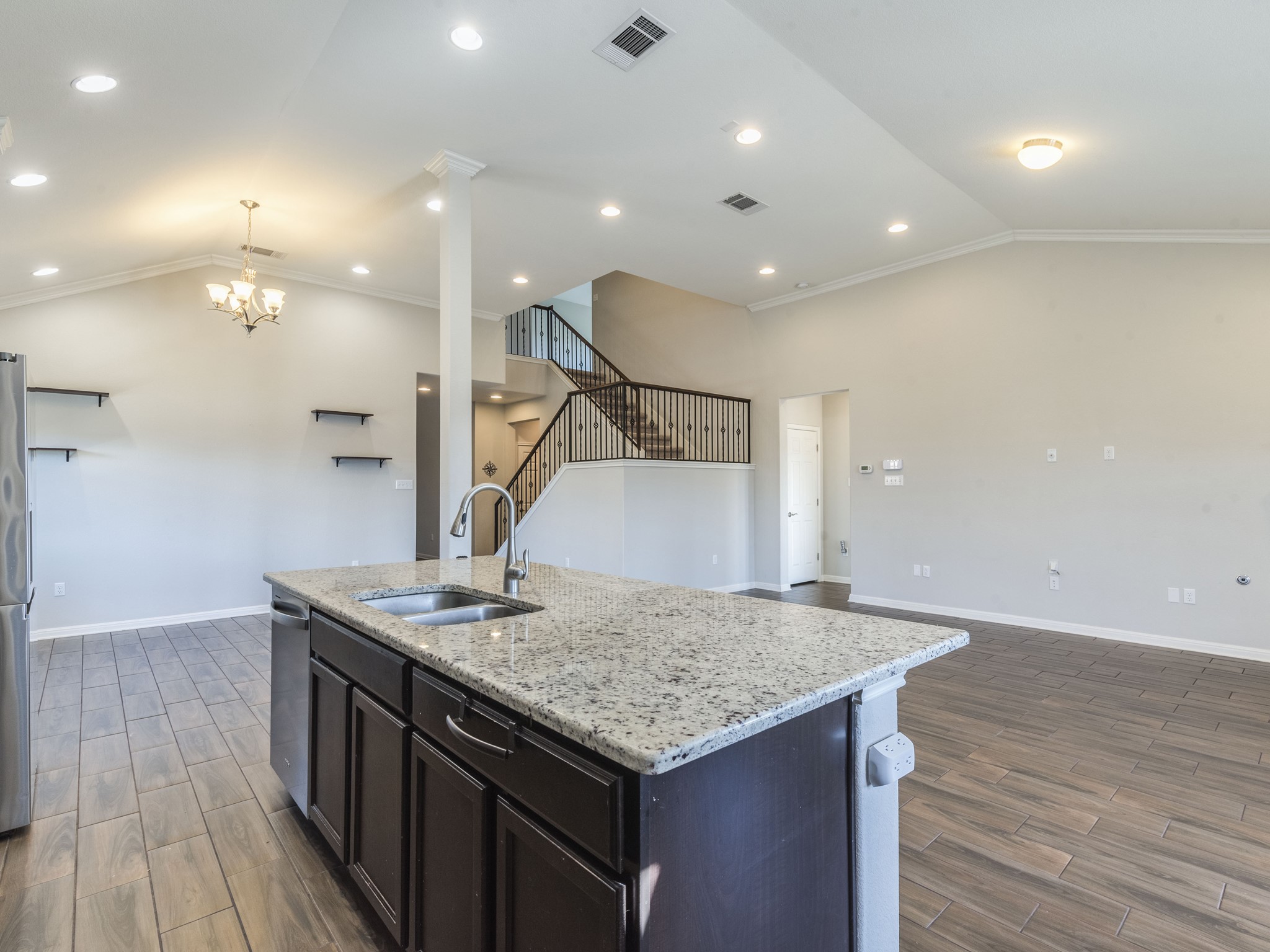 6829 Banff Cove Austin, TX 78754 - Photo 11 of 39 a kitchen with kitchen island a sink and wooden floor