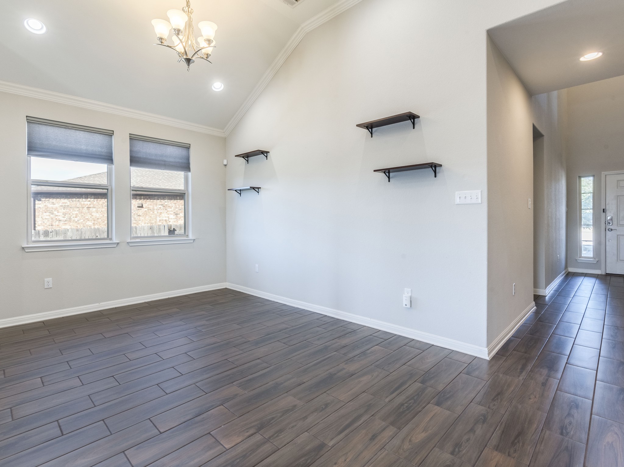 6829 Banff Cove Austin, TX 78754 - Photo 12 of 39 an empty room with wooden floor and windows