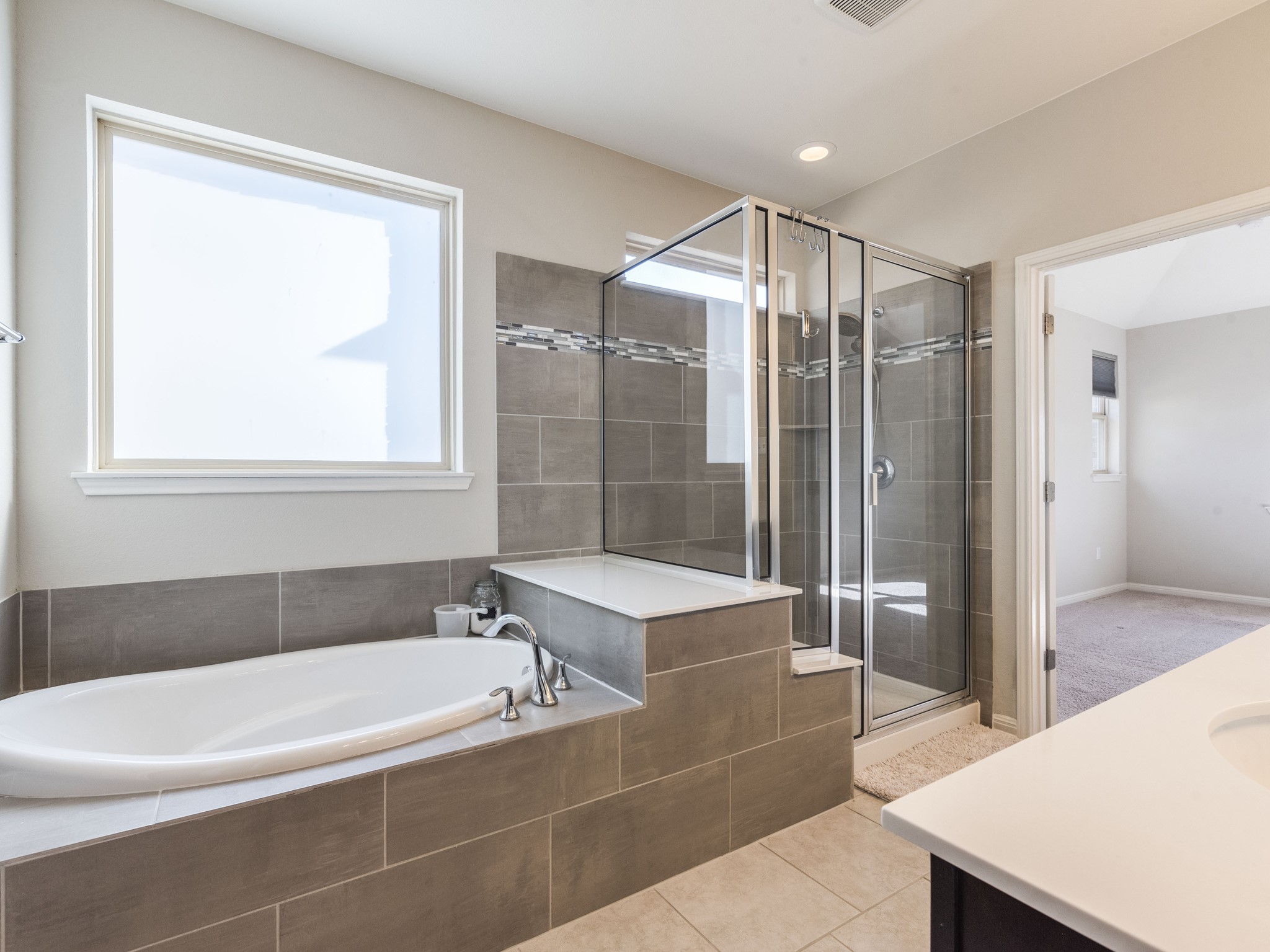 6829 Banff Cove Austin, TX 78754 - Photo 17 of 39 a bathroom with a bathtub and a shower
