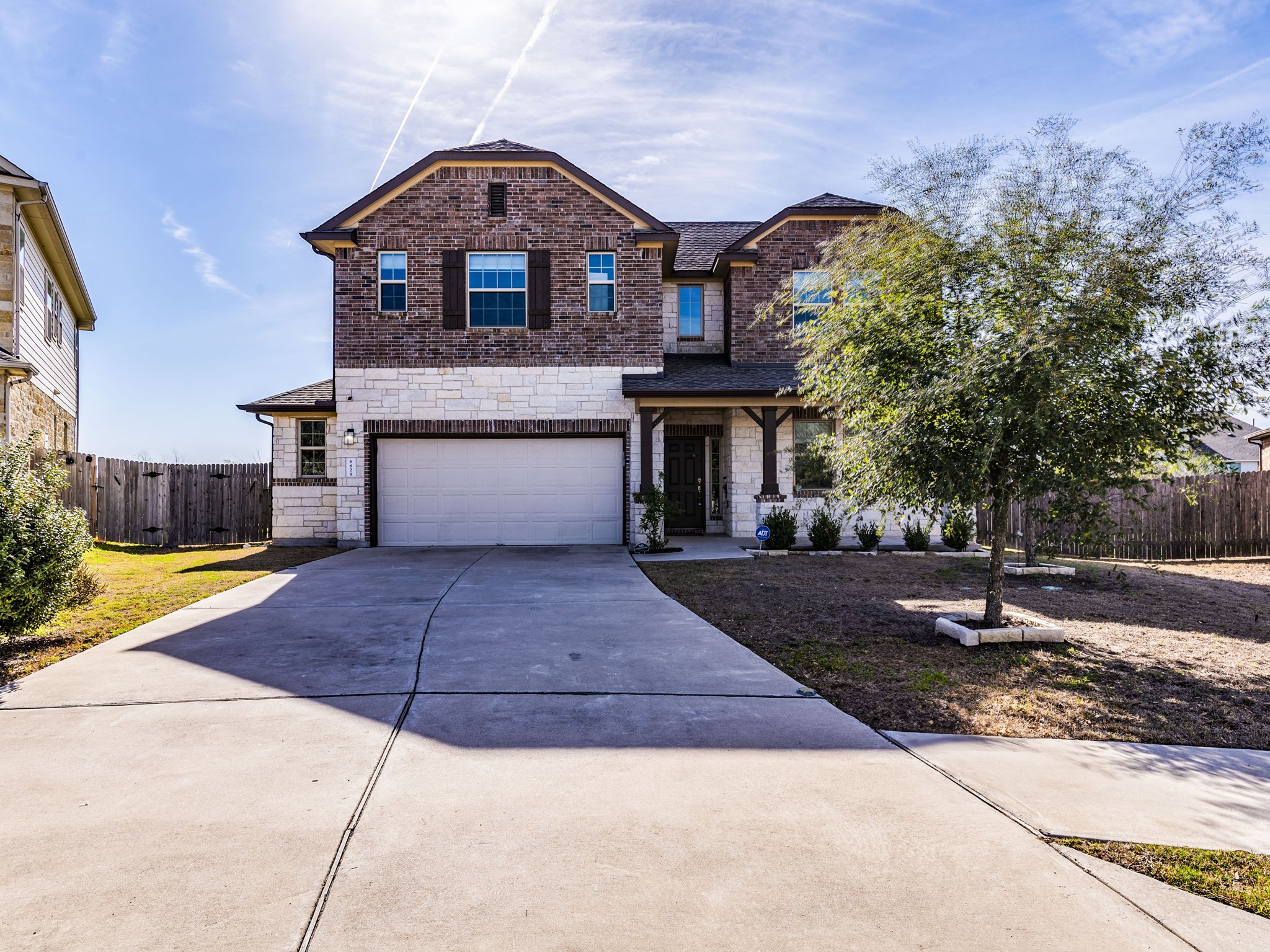 6829 Banff Cove Austin, TX 78754 - Photo 2 of 39 a front view of a house with a yard and trees