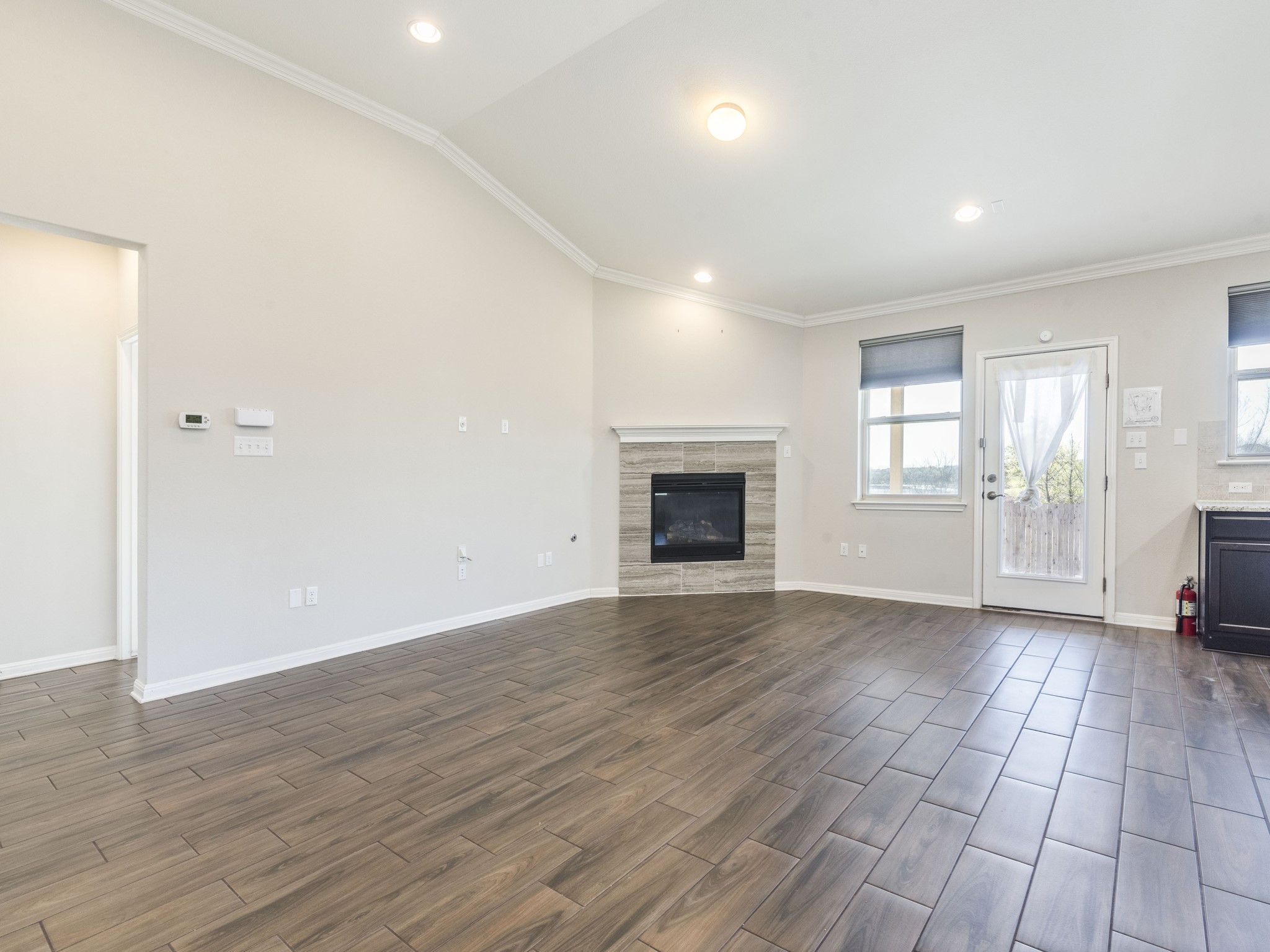 6829 Banff Cove Austin, TX 78754 - Photo 4 of 39 an empty room with wooden floor and a fireplace