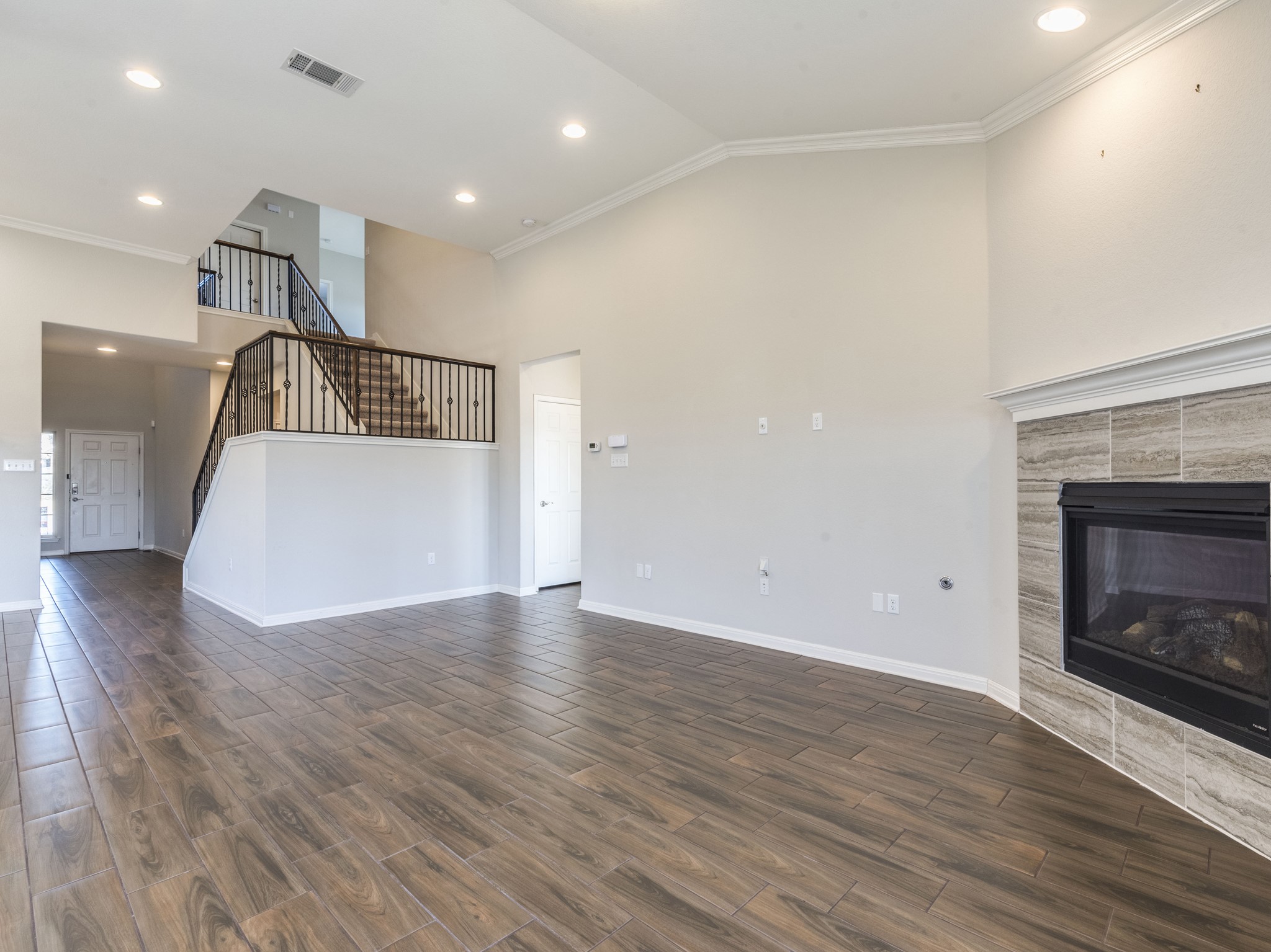 6829 Banff Cove Austin, TX 78754 - Photo 6 of 39 a view of a livingroom with wooden floor and a fireplace