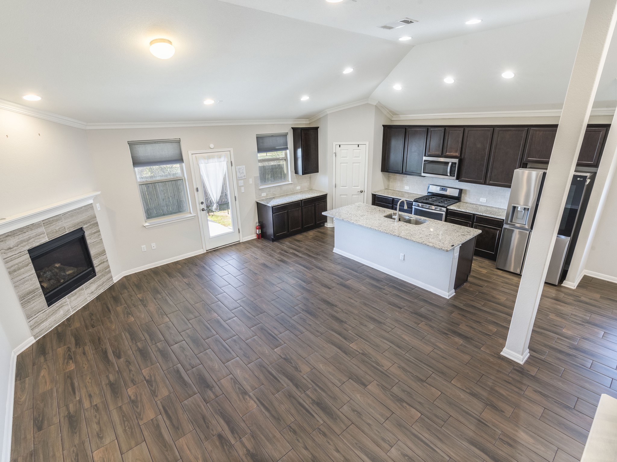 6829 Banff Cove Austin, TX 78754 - Photo 7 of 39 a living room with furniture wooden floor and a fireplace