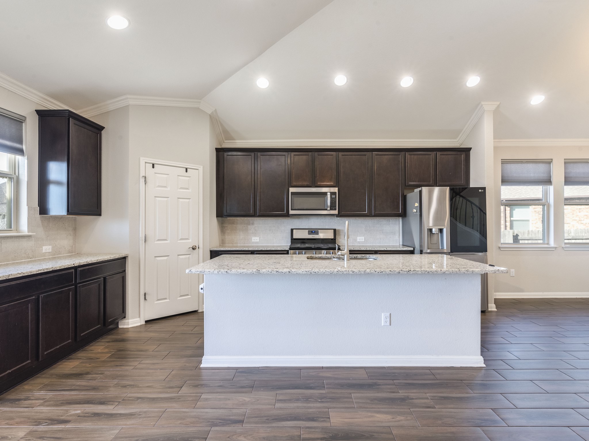 6829 Banff Cove Austin, TX 78754 - Photo 8 of 39 a large kitchen with stainless steel appliances wooden floors and wooden cabinets