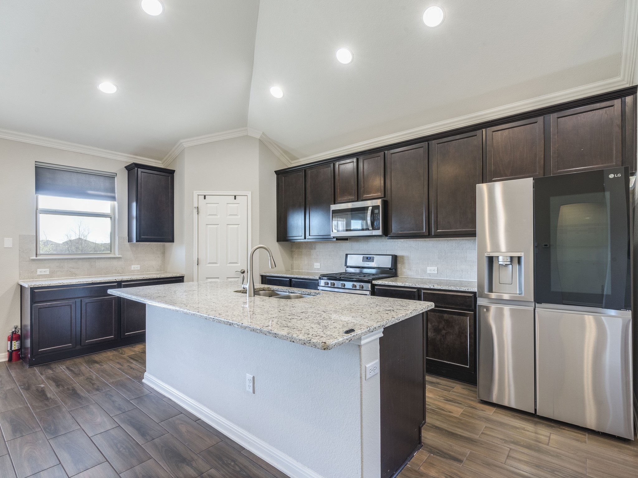 6829 Banff Cove Austin, TX 78754 - Photo 9 of 39 a kitchen with granite countertop a refrigerator stove top oven and sink