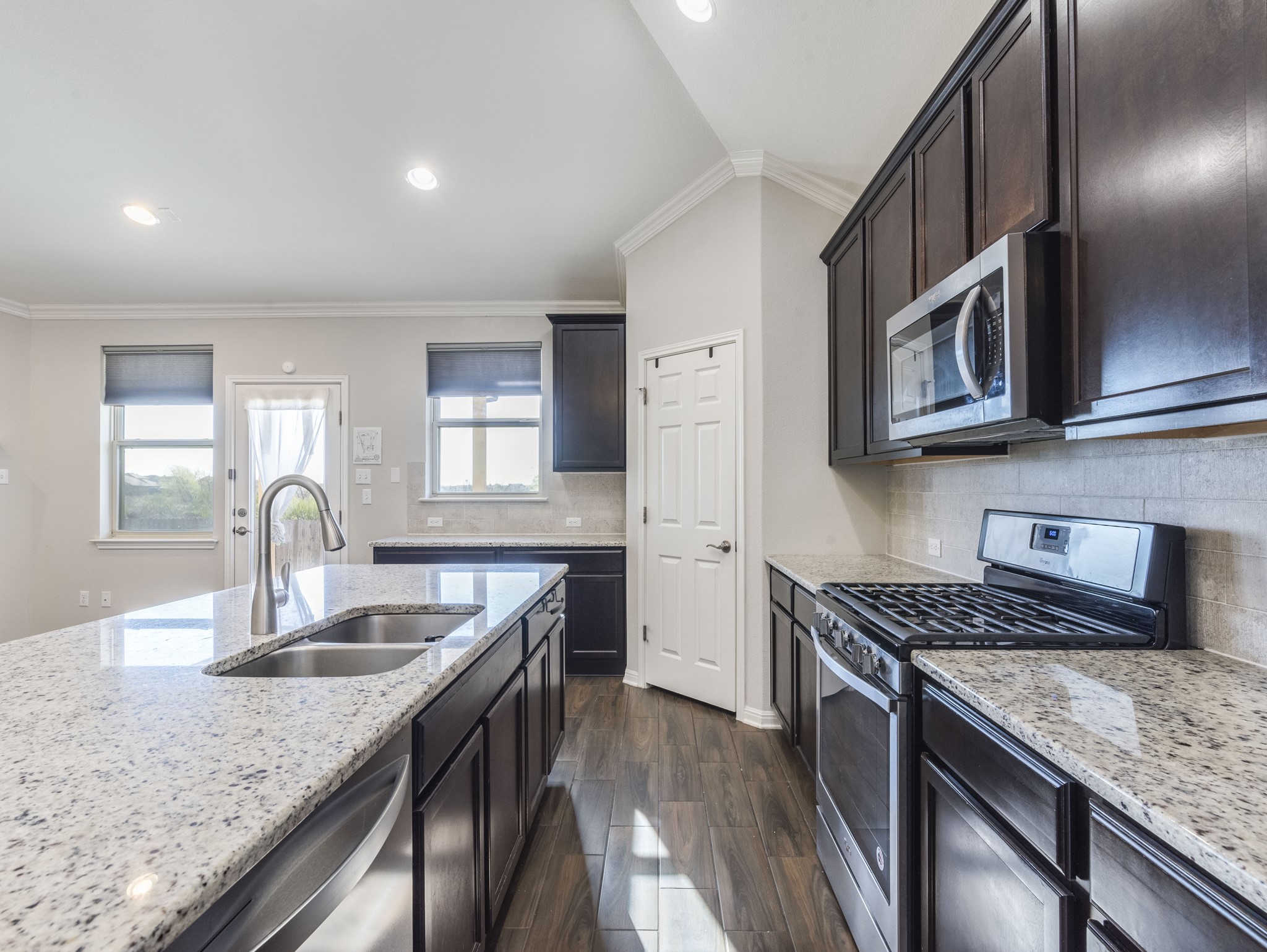 6829 Banff Cove Austin, TX 78754 - Photo 10 of 39 a kitchen with granite countertop stainless steel appliances window a sink and cabinets