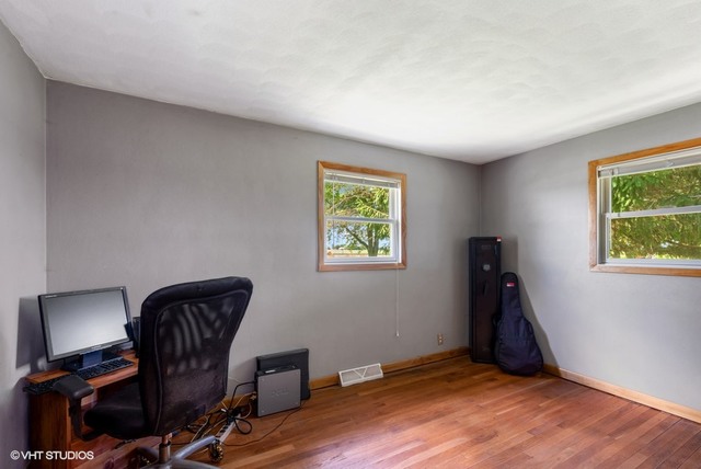 15809 Maple Park Road Maple Park, IL 60151 - Photo 11 of 19 a view of workspace with wooden floor lounge chair and windows