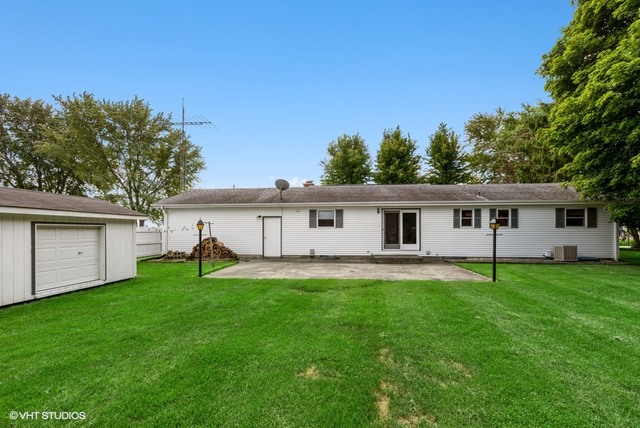 15809 Maple Park Road Maple Park, IL 60151 - Photo 17 of 19 a house that is sitting in the grass with large trees and plants