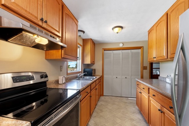 15809 Maple Park Road Maple Park, IL 60151 - Photo 6 of 19 a kitchen with sink cabinets and stove