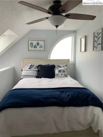 a bedroom with a bed and window