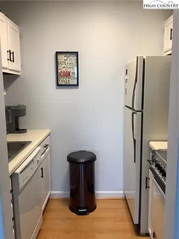 a kitchen with a refrigerator and a stove