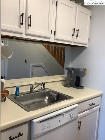 a view with a sink and cabinets