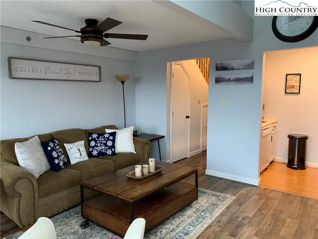 a living room with furniture and a wooden floor