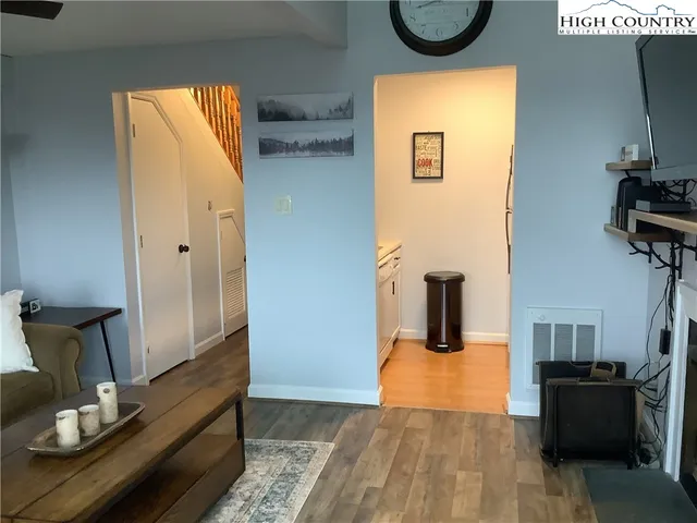 a view of living room with furniture and wooden floor