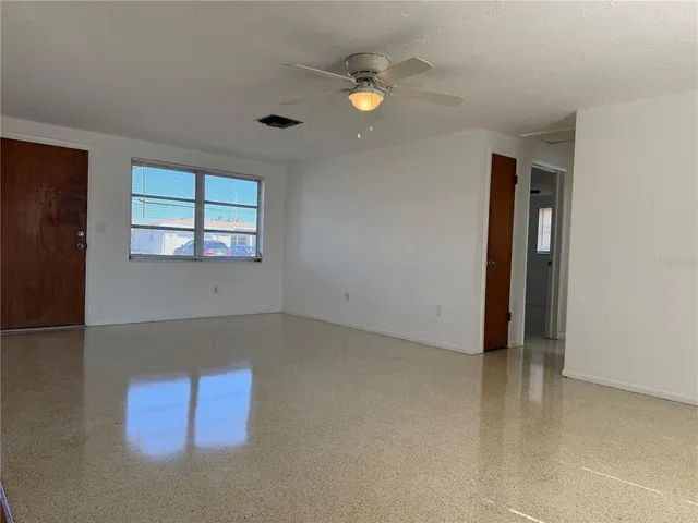 an empty room with windows and closet