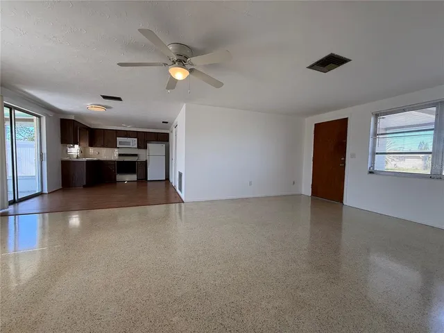 a view of livingroom with hardwood floor and ceiling fan