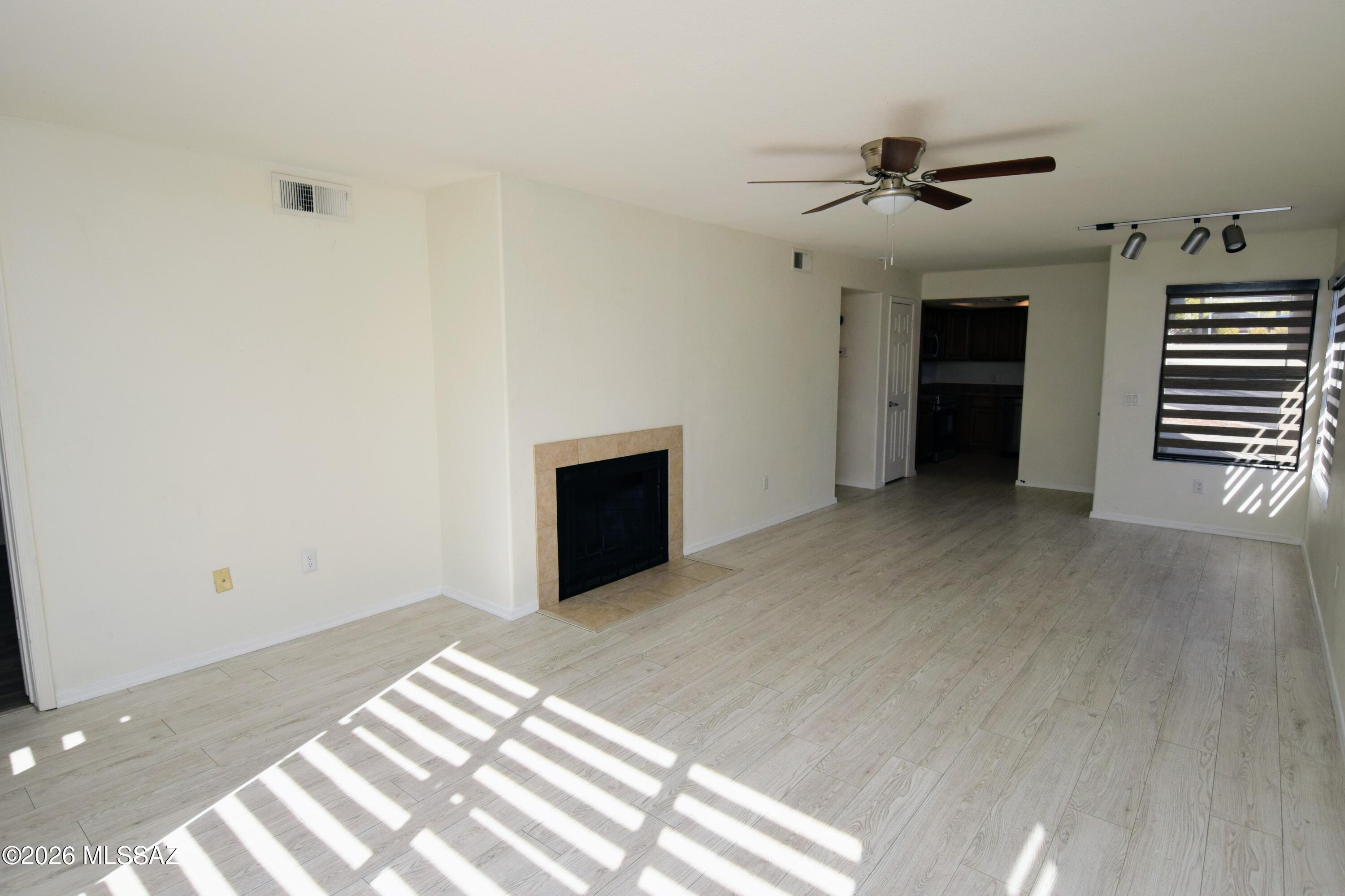 5855 North Kolb Road, Unit 11106 Tucson, AZ 85750 - Photo 5 of 36 a view of an empty room with a fireplace and a window