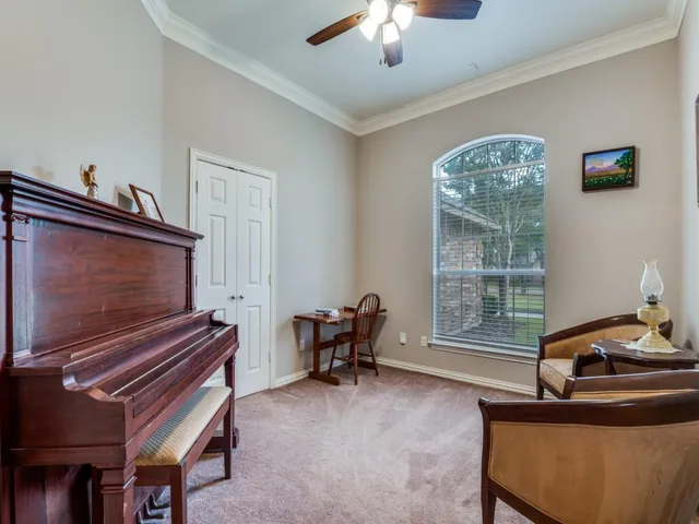 a living room with furniture and a piano