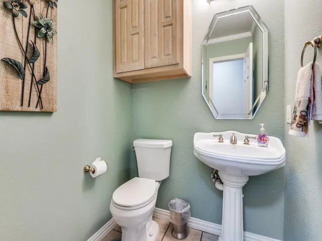 a bathroom with a sink toilet and mirror
