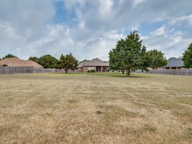 a view of a lake with houses in the back