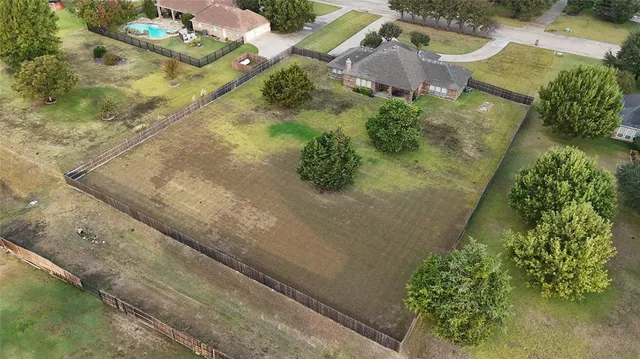 an aerial view of residential houses with outdoor space