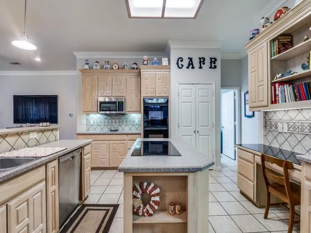 a kitchen with stainless steel appliances granite countertop a stove and a sink