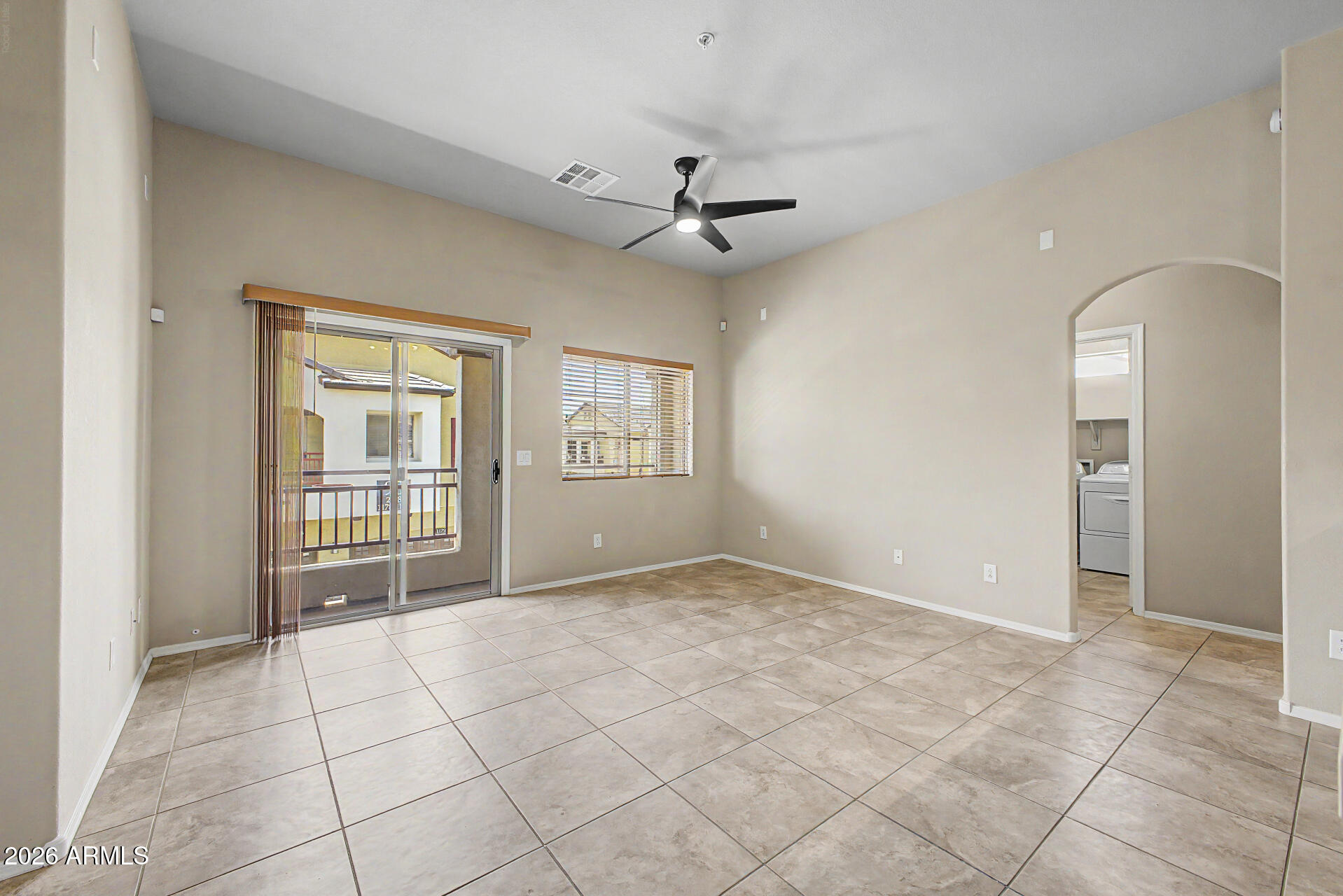 2725 East Mine Creek Road, Unit 2172 Phoenix, AZ 85024 - Photo 12 of 28 an empty room with windows and ceiling fan
