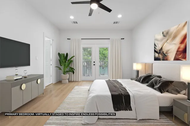 a spacious bedroom with a bed and a flat screen tv