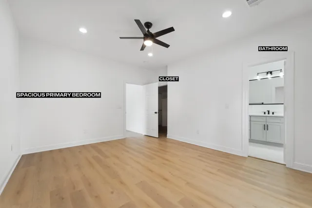 a bathroom with a sink a toilet a mirror and shower