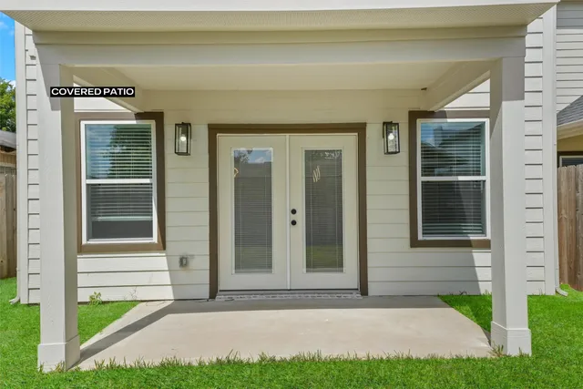 a view of a house with a yard and wooden fence