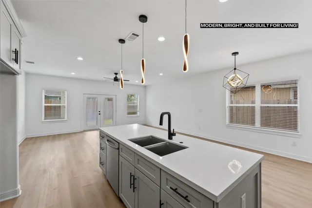 a kitchen with a sink a counter space and a window