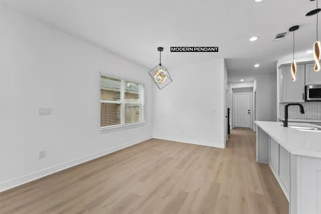 a view of a kitchen cabinets a sink and wooden floor