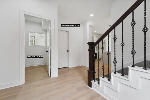 a view of an entryway with wooden floor and door