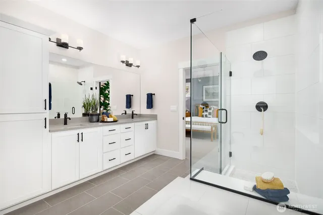 a spacious bathroom with a double sink and shower